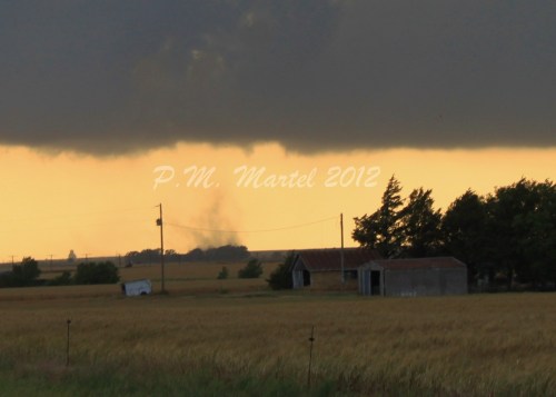 Rotation on ground, only a small portion of the funnel at cloud level is visible in this photo.